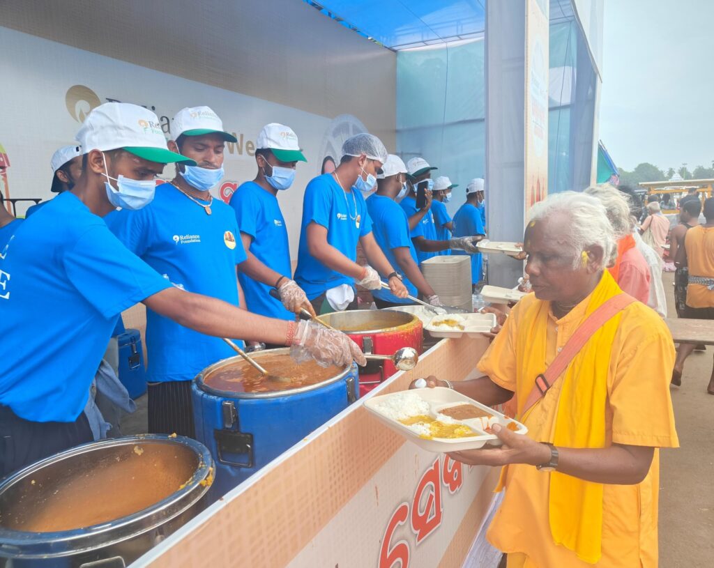 Food being  served to devotees as part of Reliance Foundation’s Anna Seva initiative in Puri